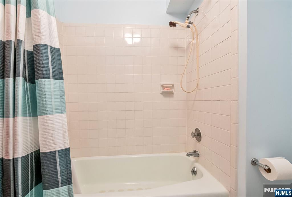 125 Prospect Avenue, Unit 16C Hackensack, NJ 07601 - Photo 31 of 35 a bathroom with a bathtub