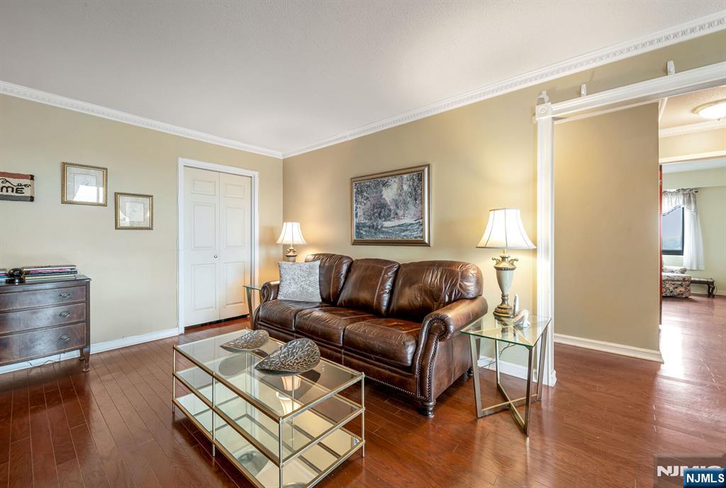 125 Prospect Avenue, Unit 16C Hackensack, NJ 07601 - Photo 9 of 35 a living room with furniture and a wooden floor
