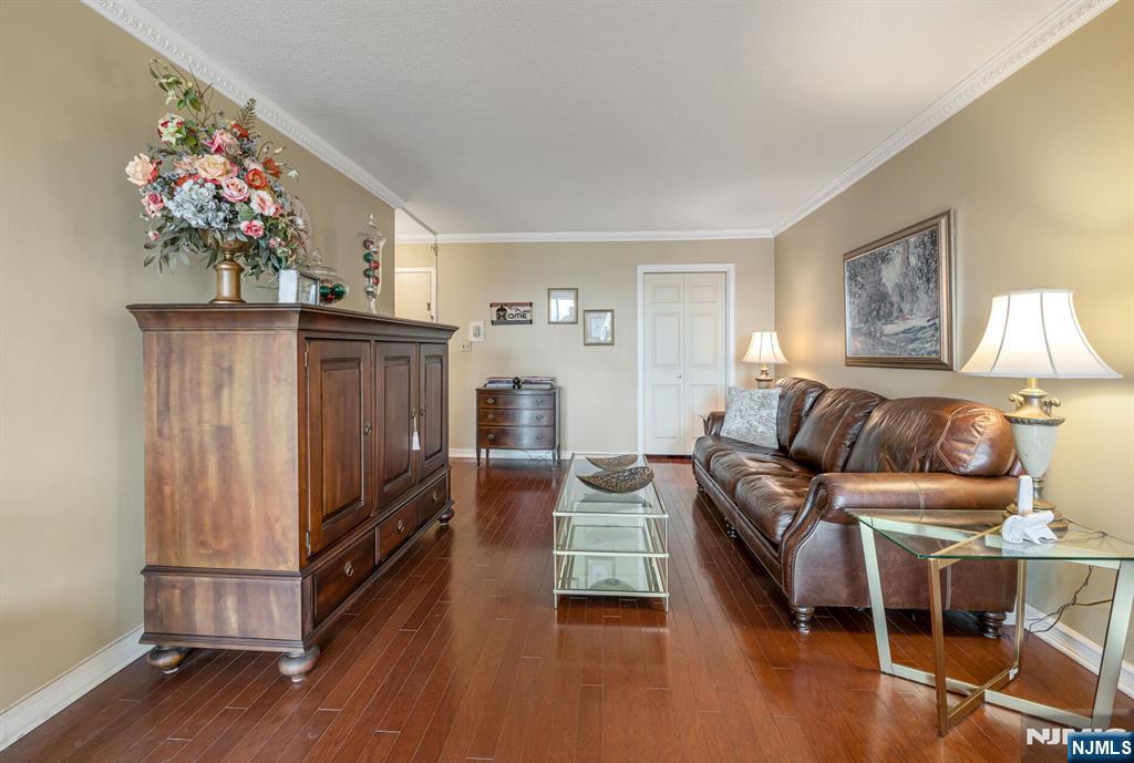 125 Prospect Avenue, Unit 16C Hackensack, NJ 07601 - Photo 10 of 35 a living room with furniture and a flat screen tv