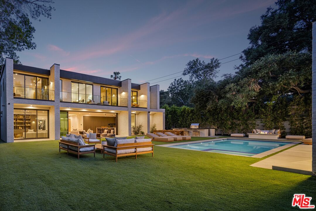 17055 Rancho Street Encino, CA 91316 - Photo 68 of 73 a view of pool with lawn chairs and a yard