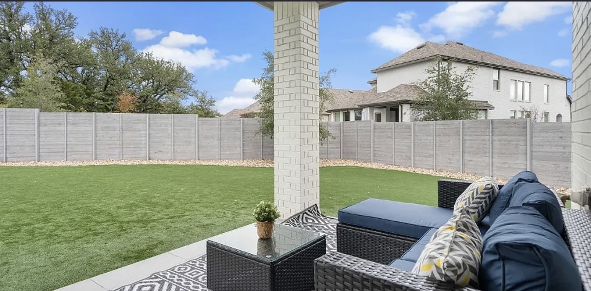 109 Arrowhead Mound Road Georgetown, TX 78628 - Photo 10 of 27 An inviting covered patio opens to a vibrant, low-maintenance lawn, perfect for relaxation and outdoor enjoyment.