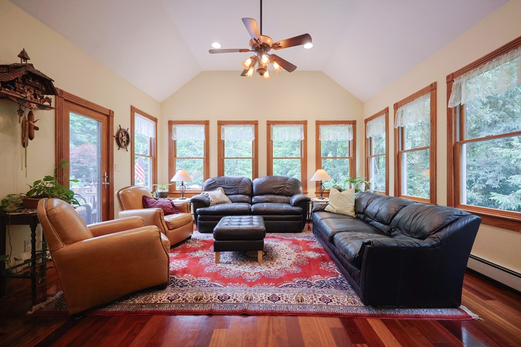 70 Azalea Way Hanson, MA 02341 - Photo 14 of 42 a living room with furniture large windows and a rug