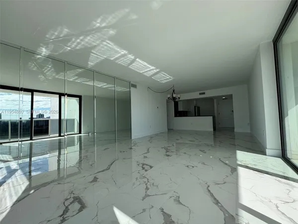 a view of a room with lots of wooden floor and windows