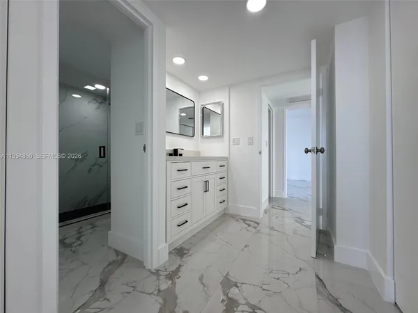 a bathroom with a double vanity sink and mirror