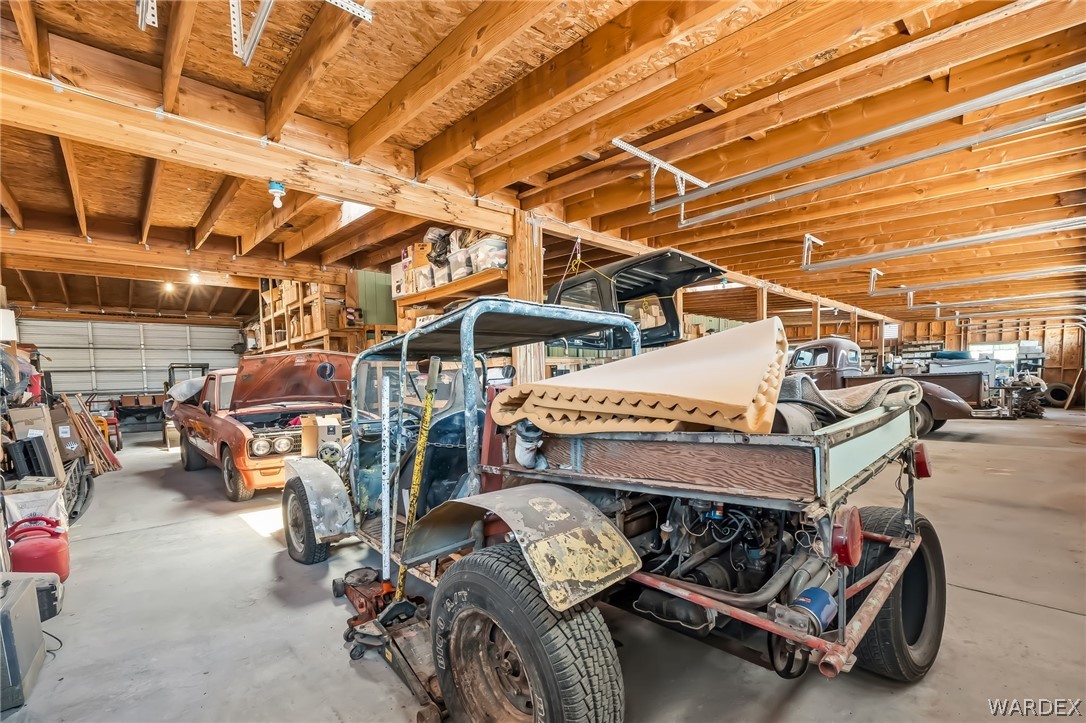 2401 North Stephan Road Kingman, AZ 86401 - Photo 72 of 92 Spacious garage featuring exposed wood beam ceilings and concrete flooring