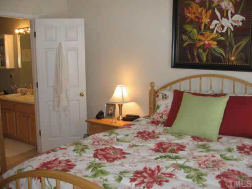 1711 Sorrell Brook Way Raleigh, NC 27609 - Photo 7 of 7 a bedroom with a bed and a mirror