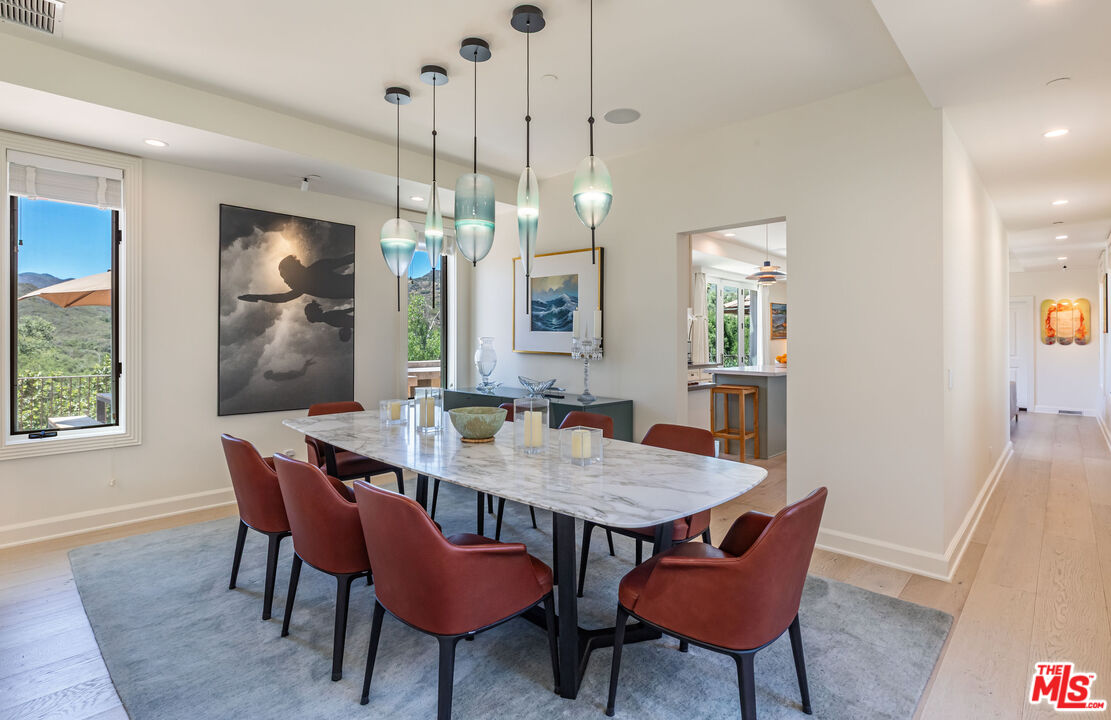 1045 Cold Canyon Road Calabasas, CA 91302 - Photo 15 of 51 a view of a dining room with furniture window and wooden floor