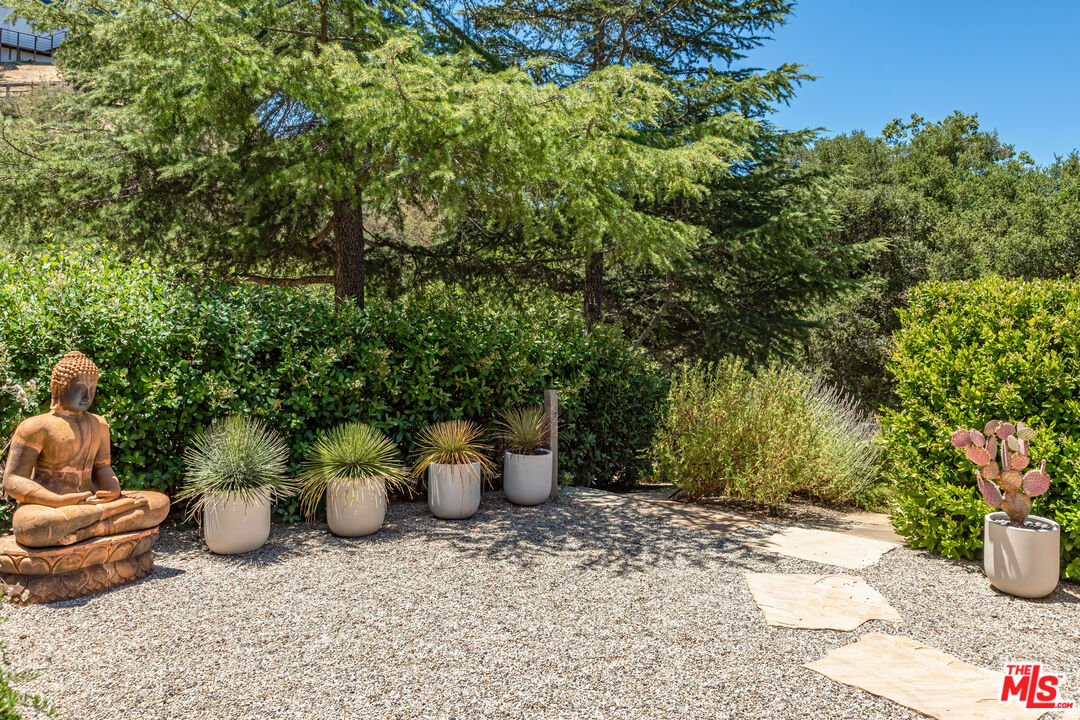 1045 Cold Canyon Road Calabasas, CA 91302 - Photo 23 of 51 a view of a backyard with sitting area and plants