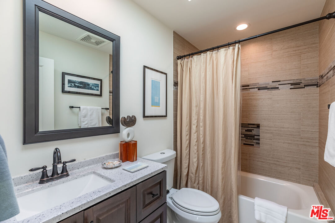 1045 Cold Canyon Road Calabasas, CA 91302 - Photo 40 of 51 a bathroom with a sink a toilet and shower
