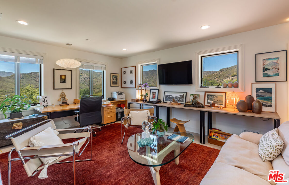 1045 Cold Canyon Road Calabasas, CA 91302 - Photo 41 of 51 a living room with fireplace furniture and a flat screen tv