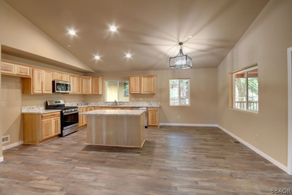 369 Riverside Avenue Sugarloaf, CA 92386 - Photo 12 of 30 a large kitchen with granite countertop a stove top oven a sink a counter space and cabinets