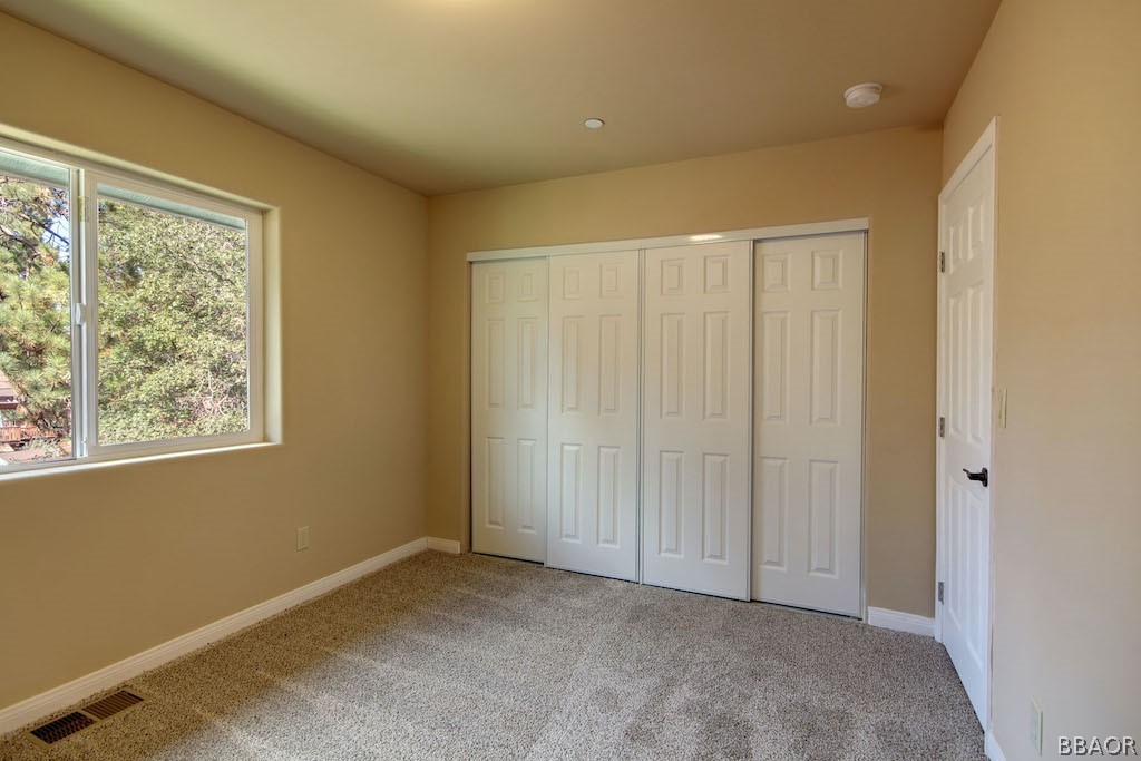 369 Riverside Avenue Sugarloaf, CA 92386 - Photo 22 of 30 an empty room with windows