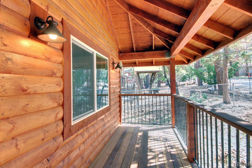 369 Riverside Avenue Sugarloaf, CA 92386 - Photo 3 of 30 a porch with wooden floor in front of a house