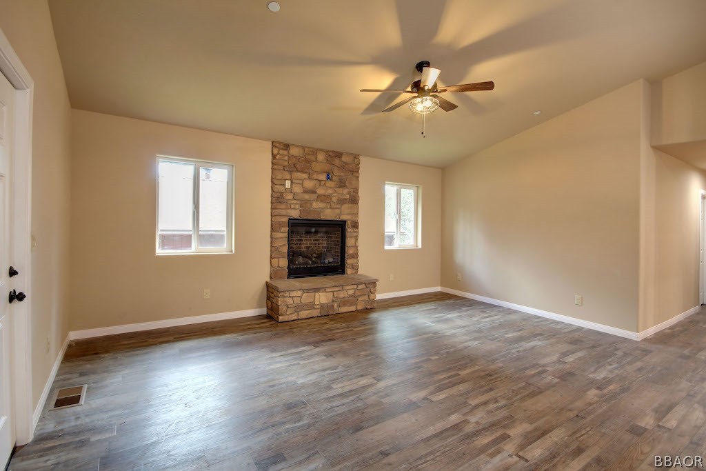 369 Riverside Avenue Sugarloaf, CA 92386 - Photo 4 of 30 an empty room with wooden floor fan and windows