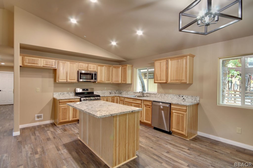 369 Riverside Avenue Sugarloaf, CA 92386 - Photo 7 of 30 a kitchen with stainless steel appliances granite countertop a sink stove and refrigerator