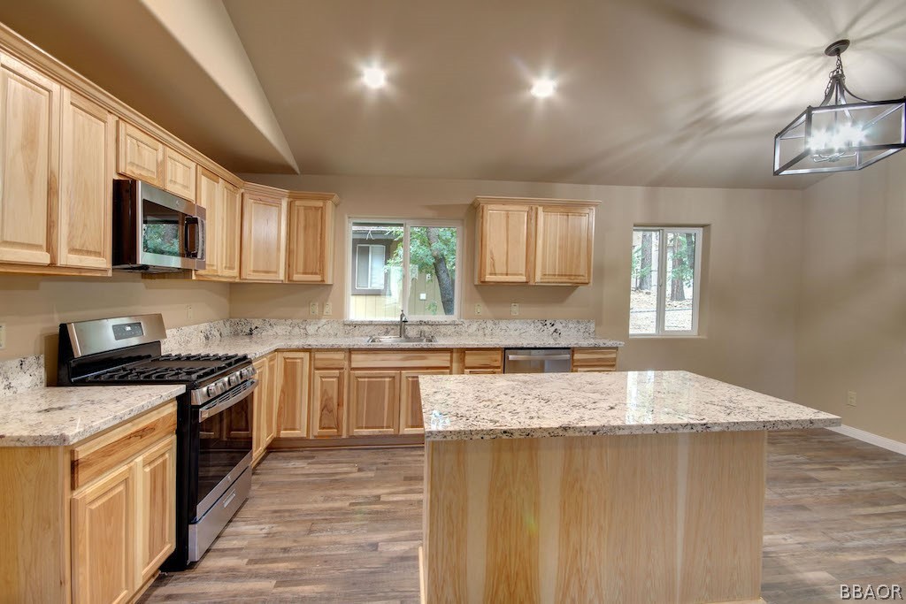369 Riverside Avenue Sugarloaf, CA 92386 - Photo 9 of 30 a large kitchen with stainless steel appliances granite countertop a stove a sink dishwasher and a microwave oven with cabinets