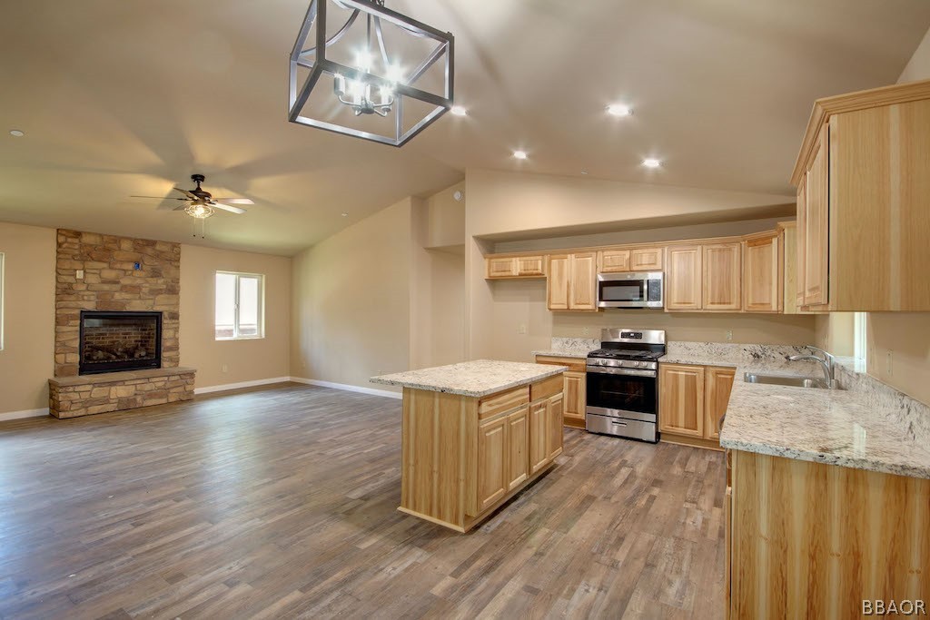 369 Riverside Avenue Sugarloaf, CA 92386 - Photo 10 of 30 a kitchen with stainless steel appliances granite countertop a sink stove and refrigerator