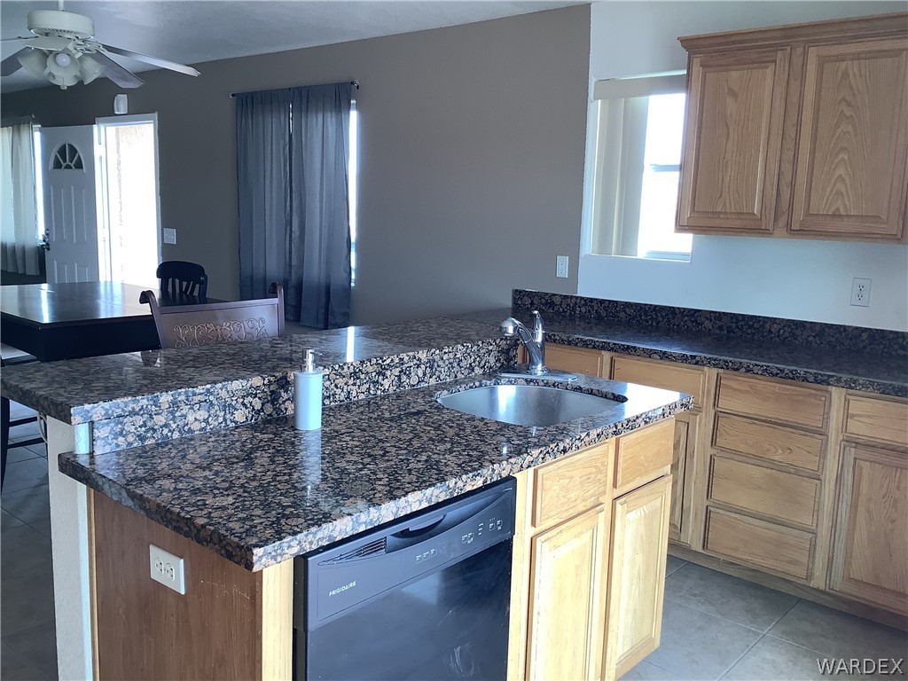 4024 Canelo Road Golden Valley, AZ 86413 - Photo 13 of 35 a kitchen with stainless steel appliances granite countertop a sink dishwasher and cabinets