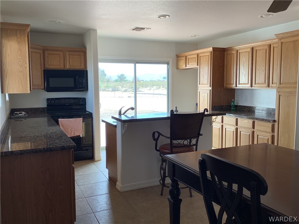 4024 Canelo Road Golden Valley, AZ 86413 - Photo 15 of 35 a kitchen with a table chairs sink and cabinets