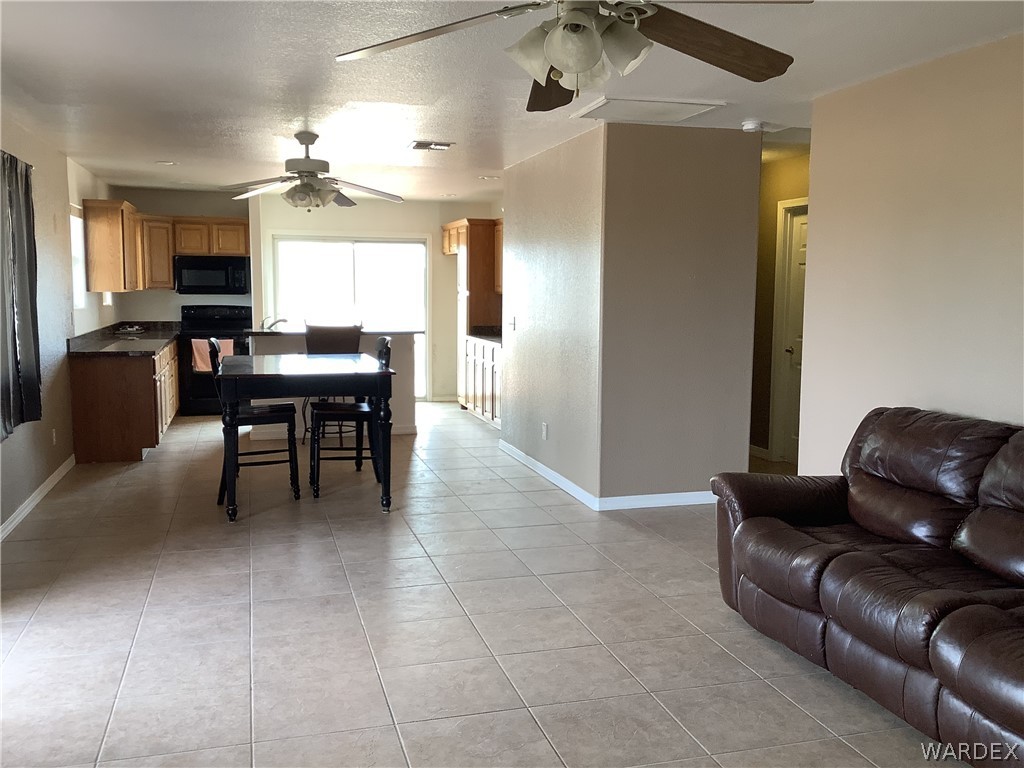 4024 Canelo Road Golden Valley, AZ 86413 - Photo 16 of 35 a living room with furniture and a dining table