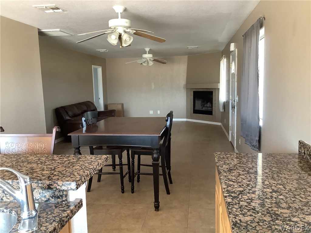 4024 Canelo Road Golden Valley, AZ 86413 - Photo 17 of 35 a living room with dining table and a fireplace
