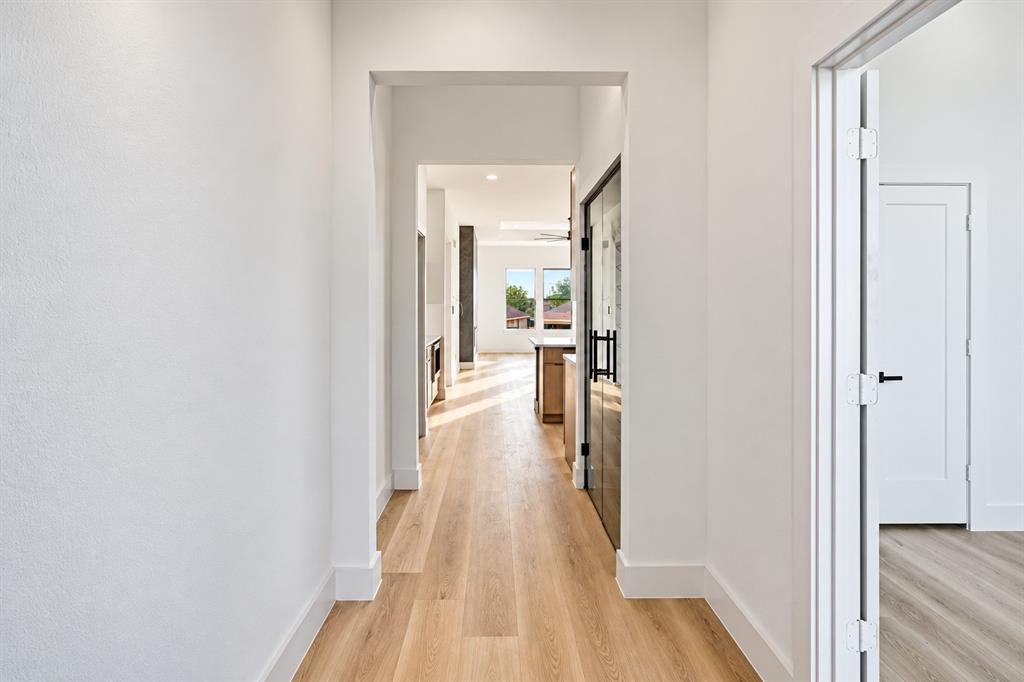 1640 West Wintergreen Road Lancaster, TX 75134 - Photo 27 of 37 Hallway with wood-finish flooring and white walls