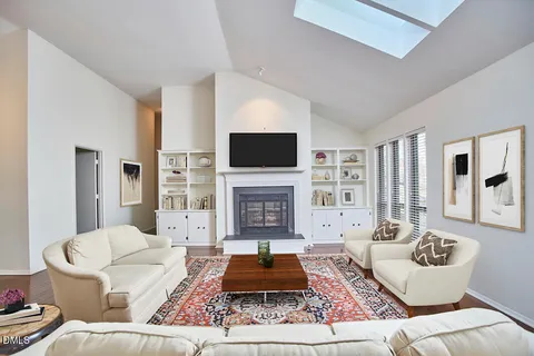 a living room with furniture a rug and a fireplace