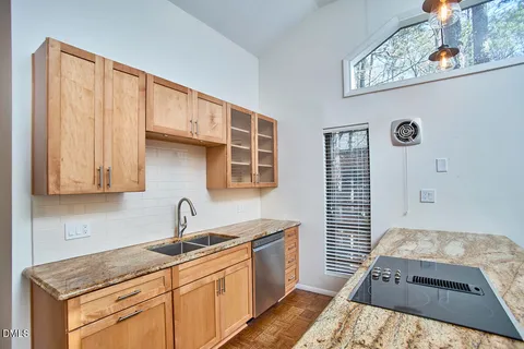 a kitchen with stainless steel appliances granite countertop a sink stove and cabinets