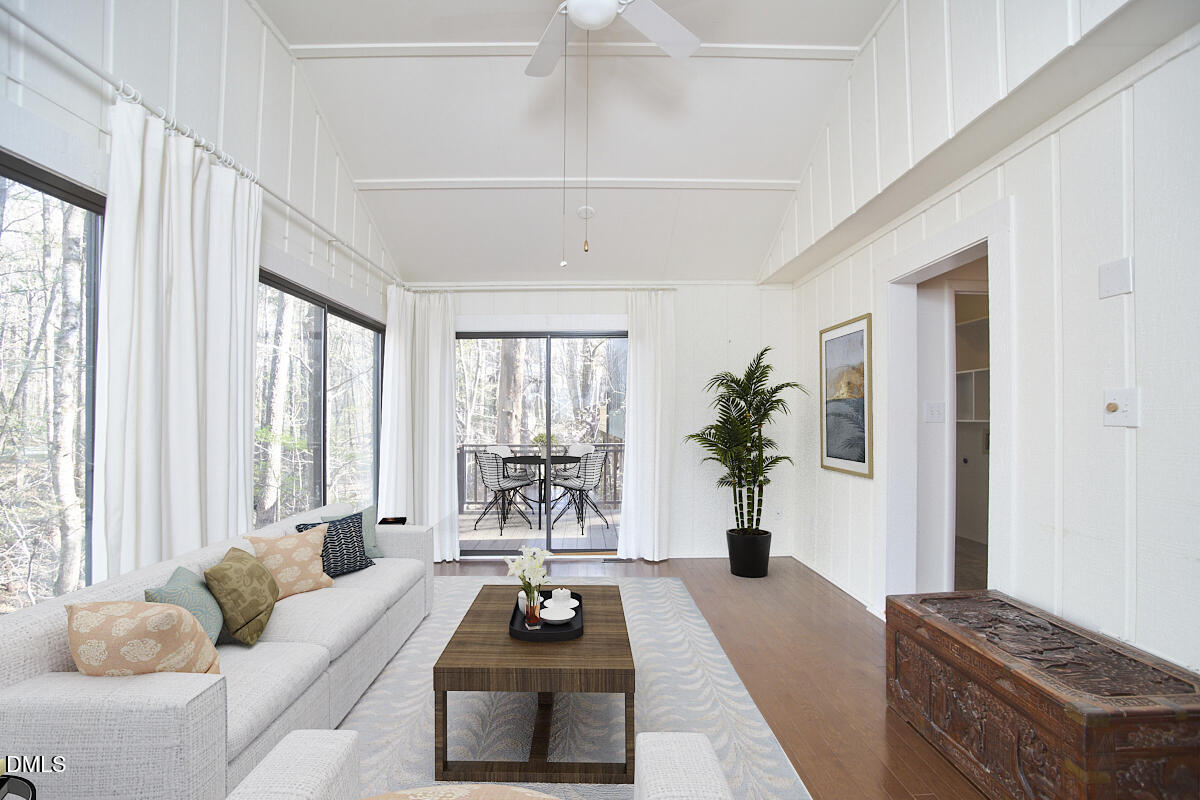 251 Fox Ridge Road Pittsboro, NC 27312 - Photo 19 of 29 a living room with furniture a chandelier and a window