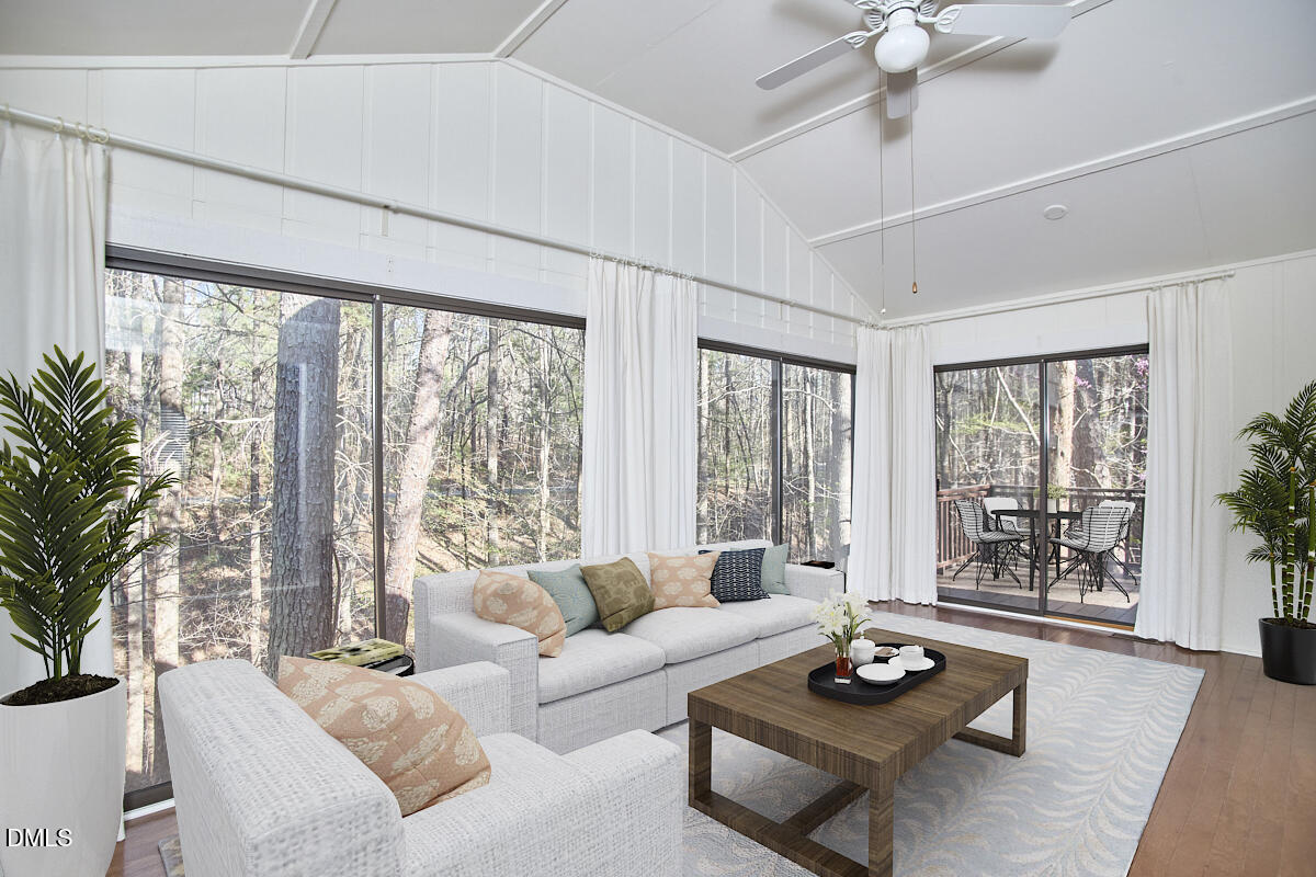 251 Fox Ridge Road Pittsboro, NC 27312 - Photo 20 of 29 a living room with furniture and floor to ceiling windows