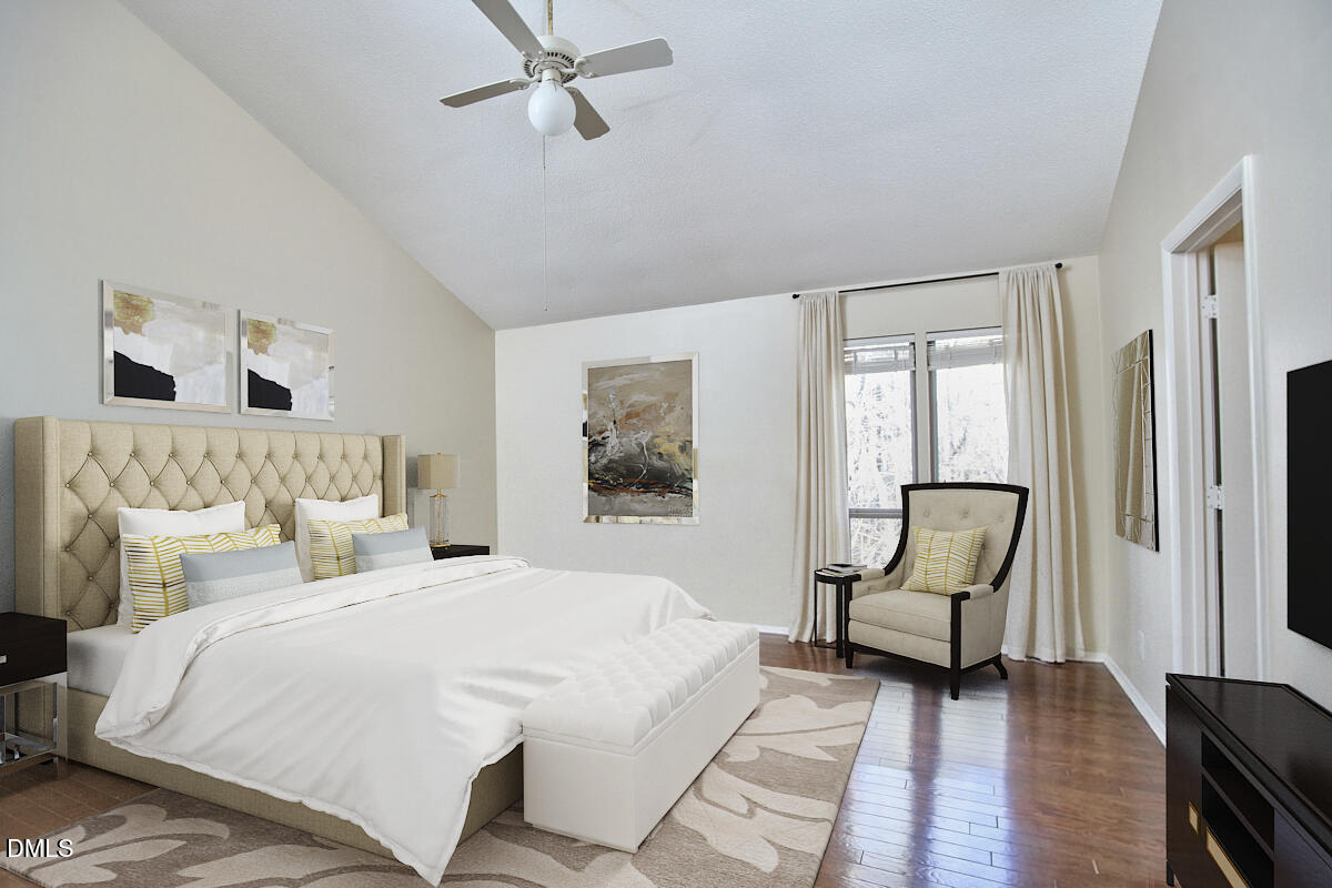 251 Fox Ridge Road Pittsboro, NC 27312 - Photo 22 of 29 a bedroom with a bed and a chandelier