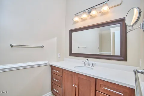 a bathroom with a sink vanity and mirror