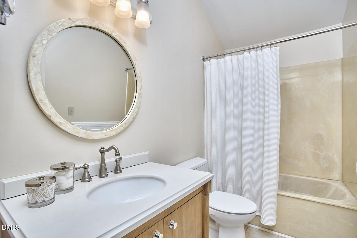 251 Fox Ridge Road Pittsboro, NC 27312 - Photo 27 of 29 a bathroom with a sink a toilet and a mirror