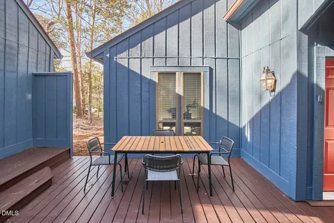 a view of a wooden chairs and table on the wooden deck