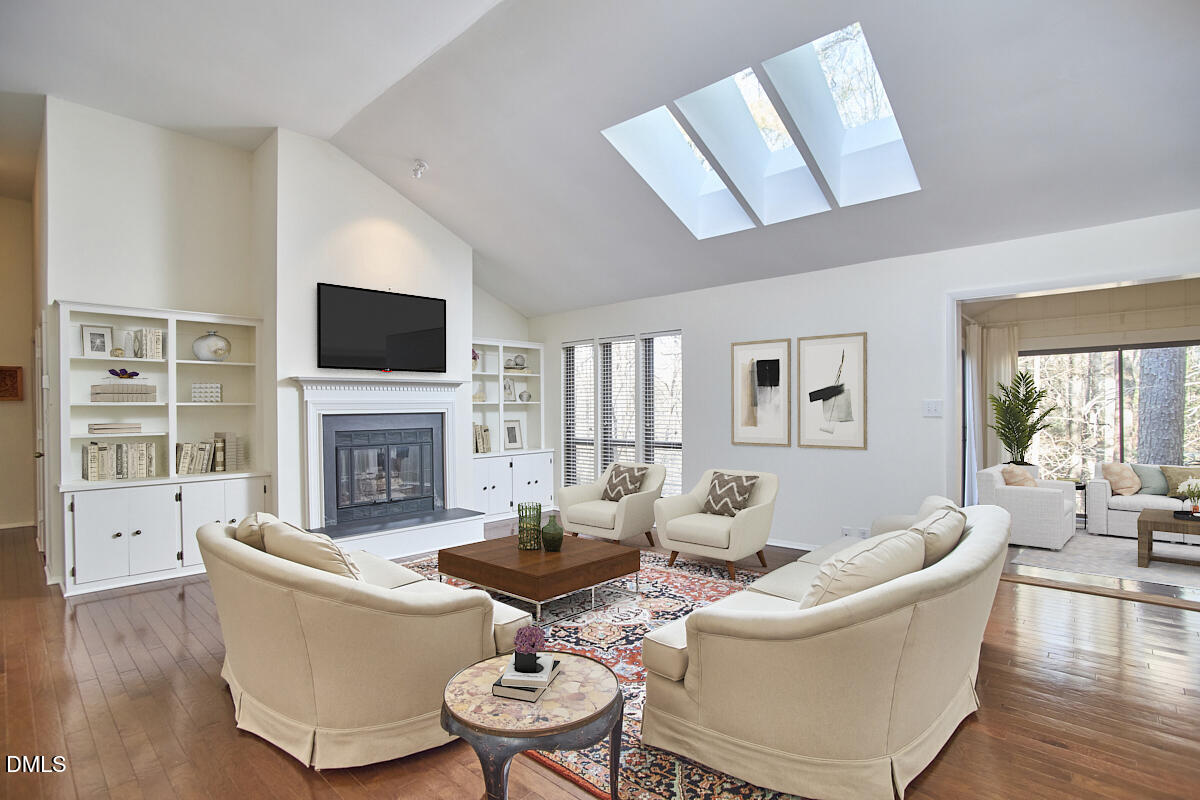 251 Fox Ridge Road Pittsboro, NC 27312 - Photo 9 of 29 a living room with furniture a fireplace and a flat screen tv