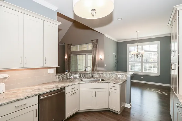 a bathroom with a granite countertop sink mirror and a large window