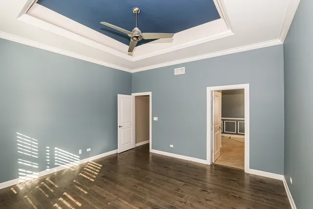 a view of a livingroom with a ceiling fan and wooden floor