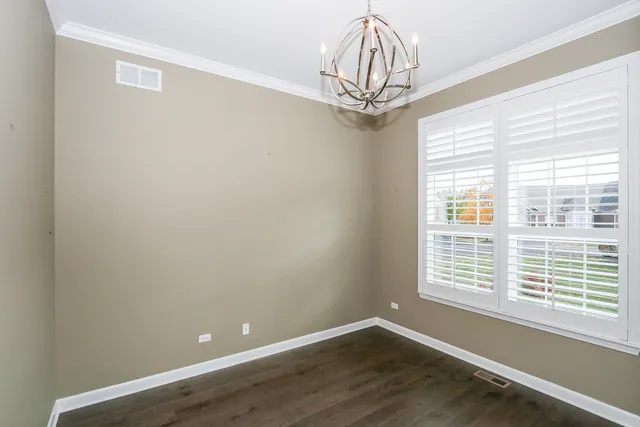 a view of a livingroom with a window and wooden floor