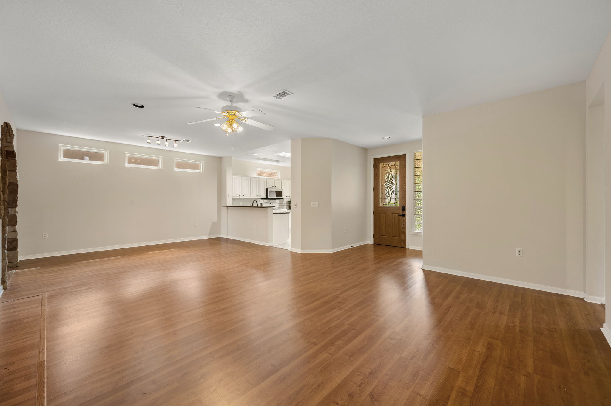 118 Bass Street Georgetown, TX 78633 - Photo 11 of 40 A well-lit living area featuring rich hardwood floors and an inviting kitchen view.