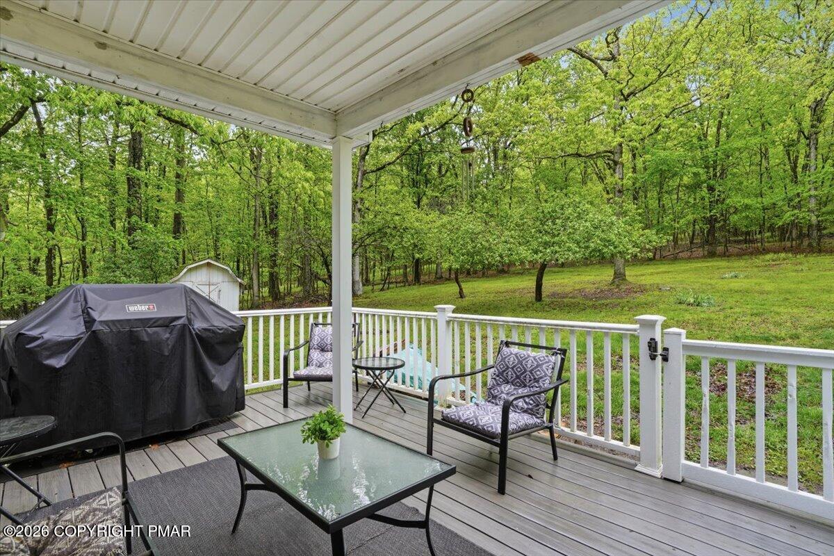 232 Garrity Road Hawley, PA 18428 - Photo 9 of 57 a view of a deck with furniture and a yard