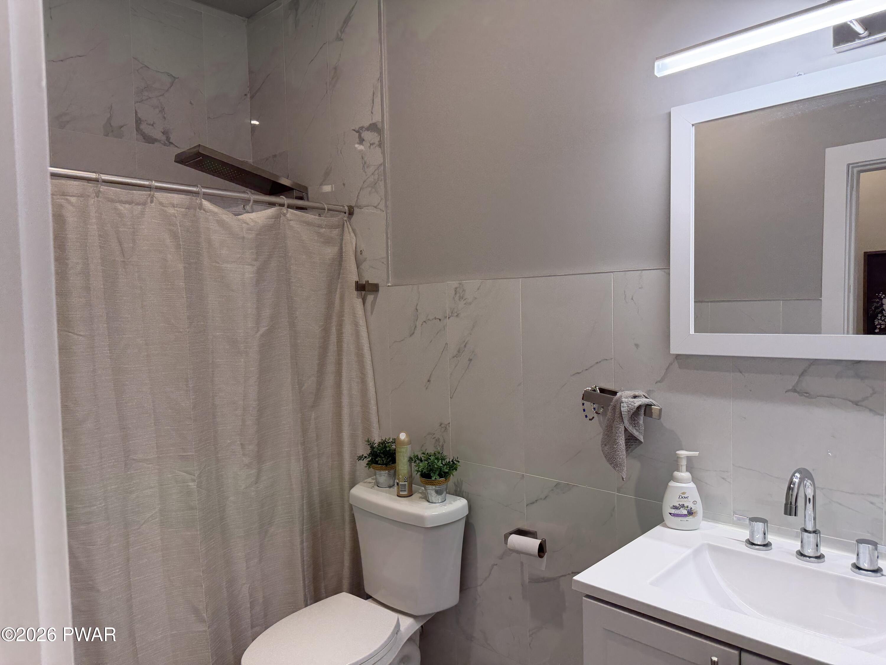 801 Maple Ridge Court Hawley, PA 18428 - Photo 34 of 55 a bathroom with a sink toilet and shower