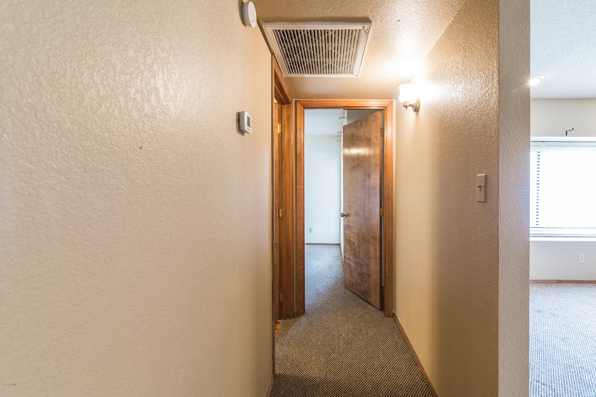 542 South Higley Road, Unit 78 Mesa, AZ 85206 - Photo 13 of 17 a view of a bathroom from a hallway