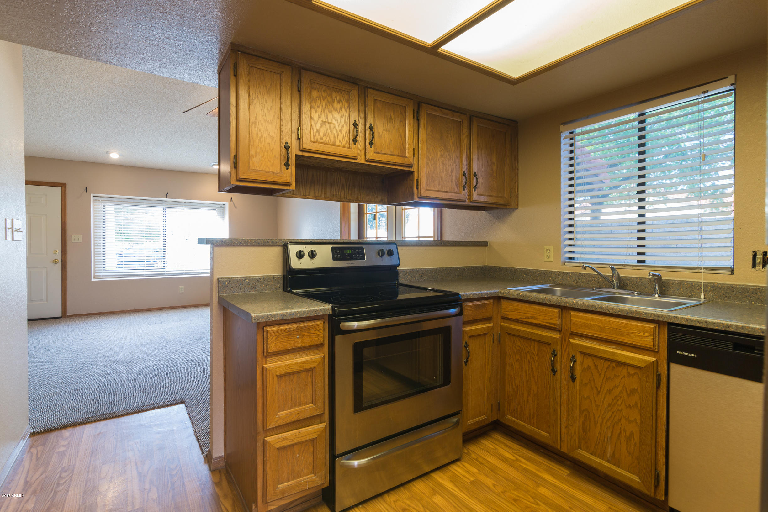 542 South Higley Road, Unit 78 Mesa, AZ 85206 - Photo 2 of 17 a kitchen with stainless steel appliances granite countertop a stove a sink and a microwave