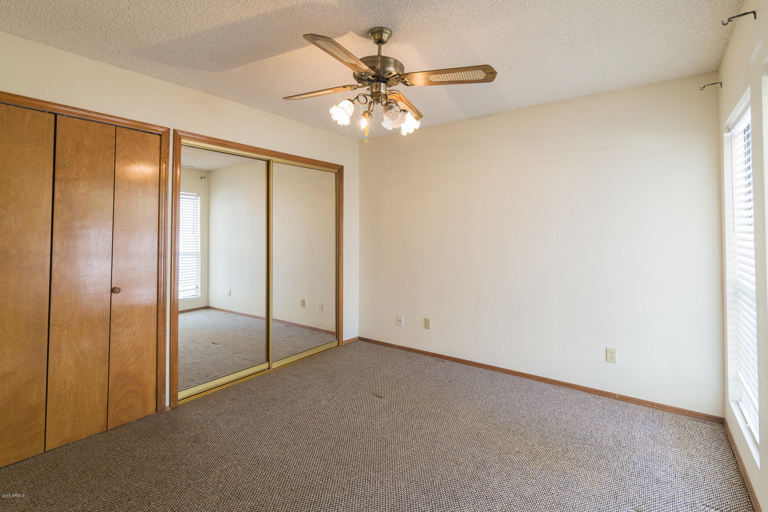 542 South Higley Road, Unit 78 Mesa, AZ 85206 - Photo 3 of 17 a view of an empty room with a ceiling fan