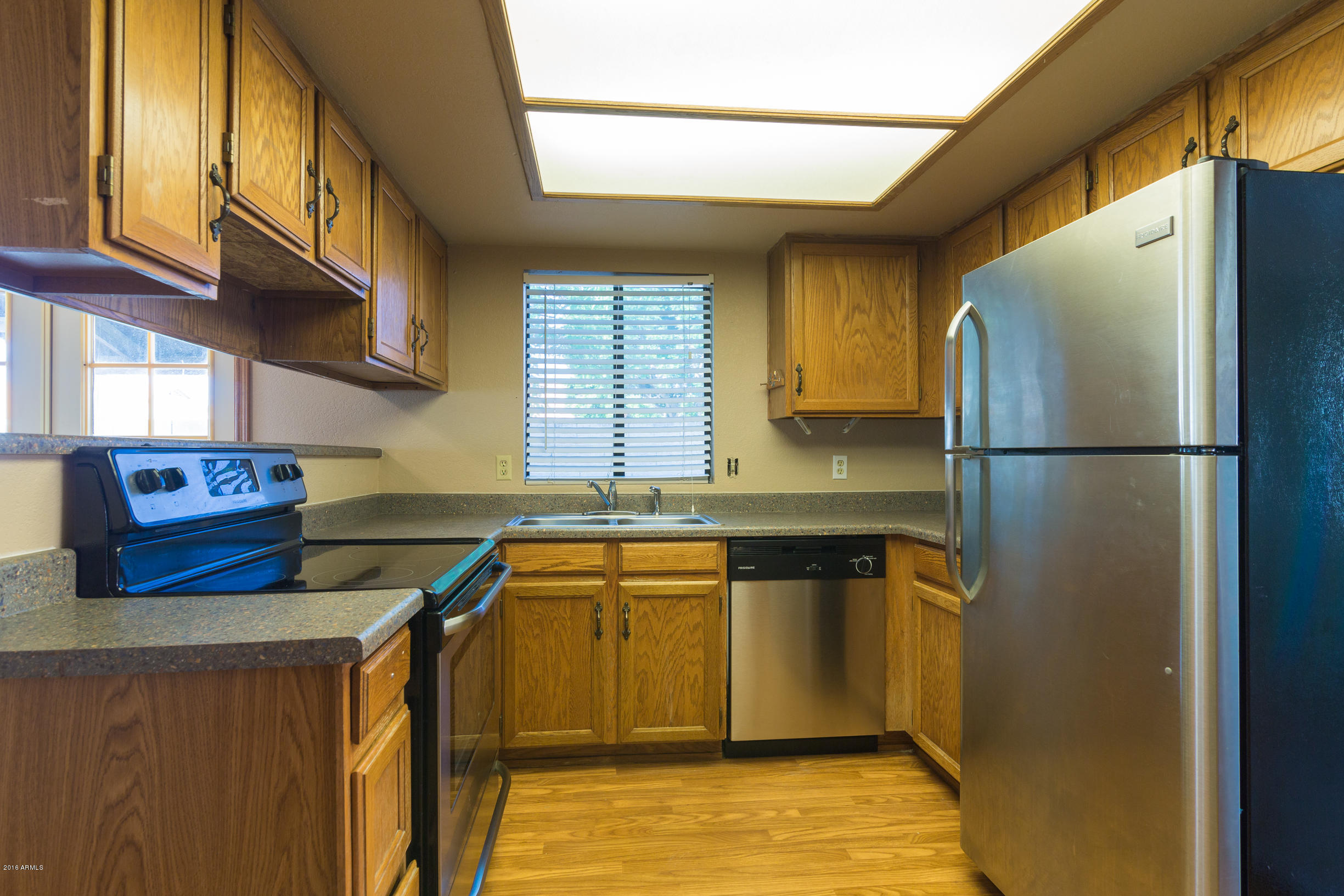 542 South Higley Road, Unit 78 Mesa, AZ 85206 - Photo 7 of 17 a kitchen with stainless steel appliances granite countertop a sink stove and refrigerator