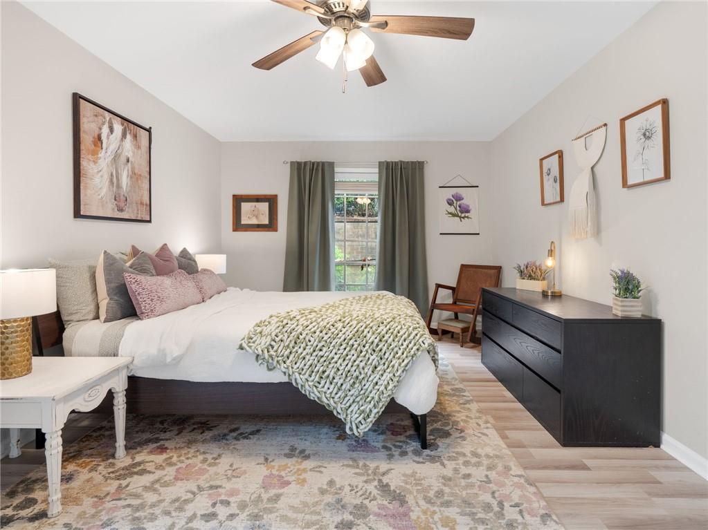 6851 Roswell Road, Unit H26 Atlanta, GA 30328 - Photo 13 of 49 a bed room with a bed and a chandelier