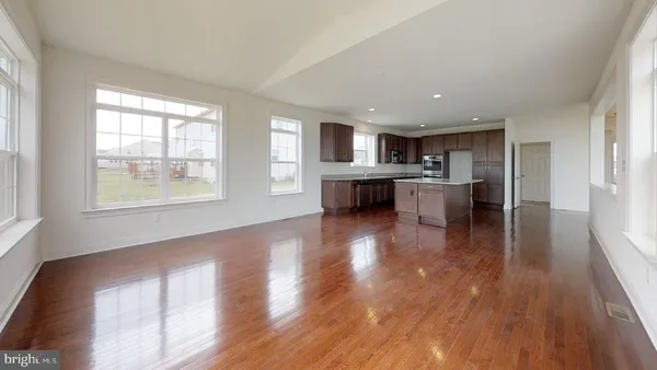 a view of kitchen with sink and wooden floor