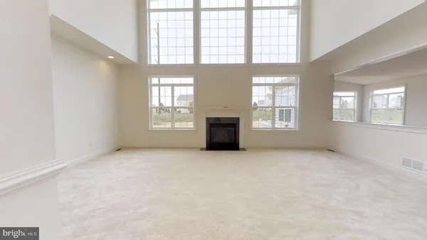a view of living room with furniture and a fireplace