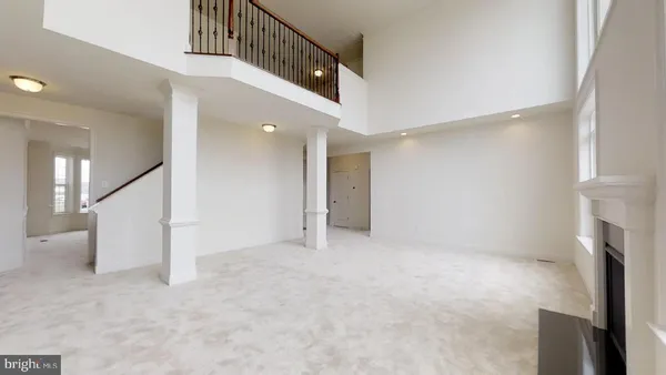 a view of a hallway with wooden floor and windows