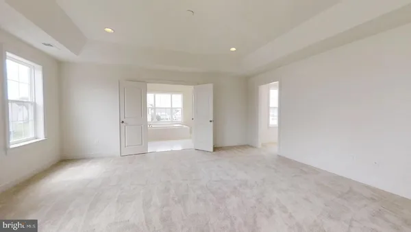 an empty room with windows and closet
